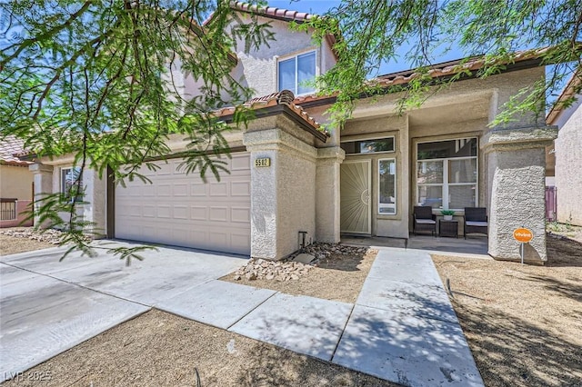 5502 Cinnamon Ave, Las Vegas, NV 89122 - mediterranean / spanish-style house featuring concrete driveway, stucco siding, and a tile roof
