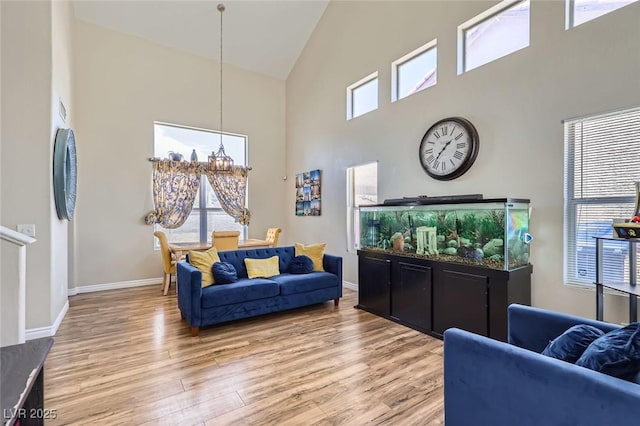 5502 Cinnamon Ave, Las Vegas, NV 89122 - living room with high vaulted ceiling, light wood-type flooring, healthy amount of natural light, and baseboards