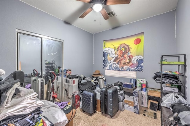 misc room with a ceiling fan and carpet