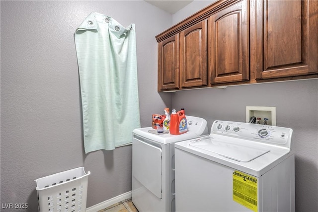 washroom with separate washer and dryer and cabinet space