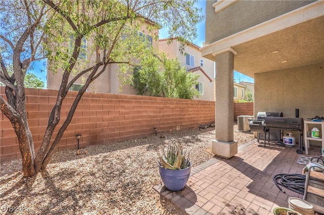 view of patio / terrace featuring central AC, a fenced backyard, and a grill
