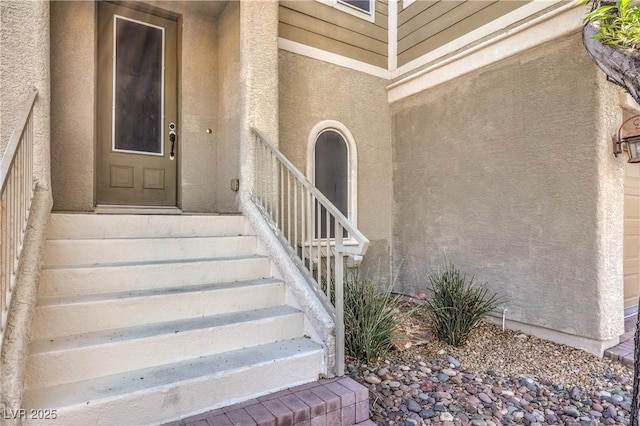 view of exterior entry featuring stucco siding