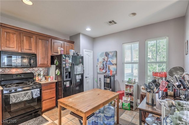 kitchen featuring black appliances, tasteful backsplash, light countertops, recessed lighting, and brown cabinets