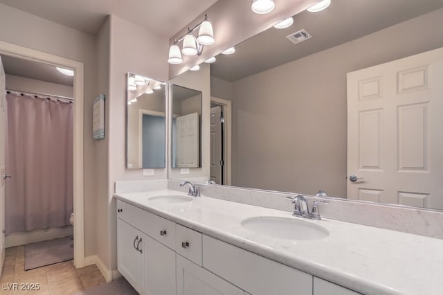 10047 Alden Creek St, Las Vegas, NV 89141 - bathroom with double vanity, tile patterned floors, curtained shower, and baseboards