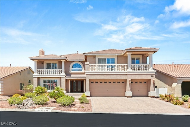4542 Grey Spencer Dr, Las Vegas, NV 89141 - view of front of property featuring a balcony, stucco siding, an attached garage, and concrete driveway