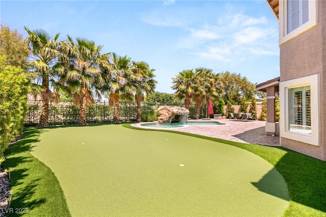 4542 Grey Spencer Dr, Las Vegas, NV 89141 - view of yard featuring an area to practice putting, a patio area, and fence