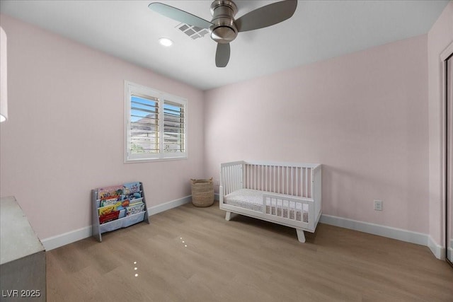 10470 Dove Meadow Way, Las Vegas, NV 89135 - unfurnished bedroom with wood finished floors, baseboards, and a crib