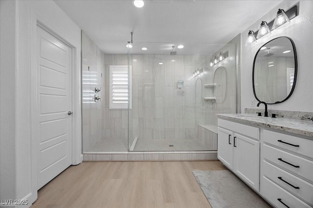 10470 Dove Meadow Way, Las Vegas, NV 89135 - full bathroom with wood finished floors, a tile shower, vanity, and recessed lighting