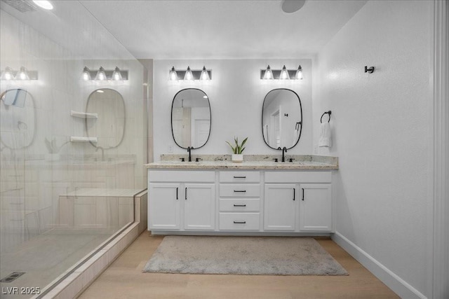 10470 Dove Meadow Way, Las Vegas, NV 89135 - full bath with double vanity, a tile shower, wood finished floors, and baseboards