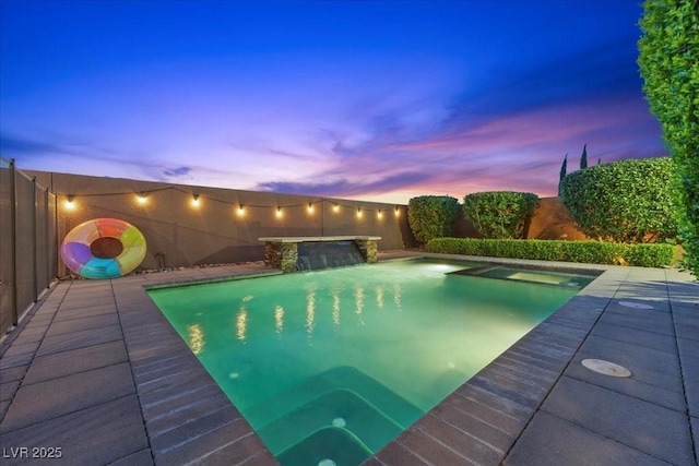 10470 Dove Meadow Way, Las Vegas, NV 89135 - pool at dusk featuring a fenced backyard and a pool with connected hot tub