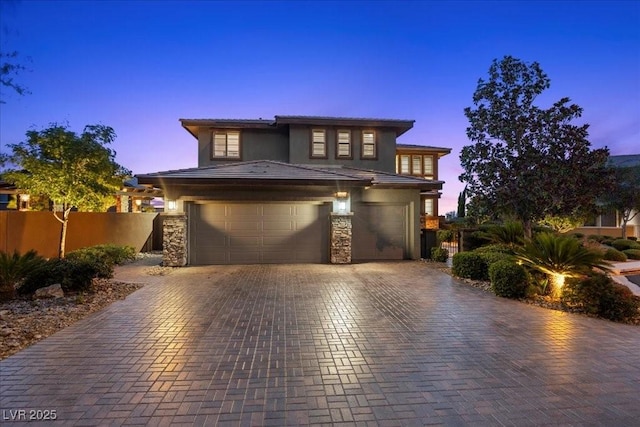 10470 Dove Meadow Way, Las Vegas, NV 89135 - prairie-style home featuring a garage, decorative driveway, stucco siding, and stone siding