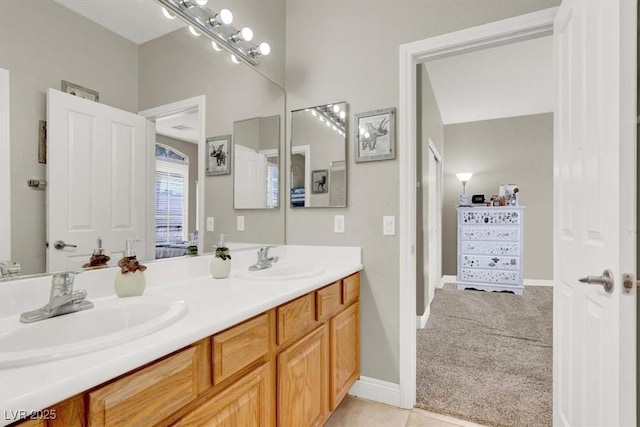 7310 Heggie Ave, Las Vegas, NV 89131 - full bathroom with double vanity and baseboards