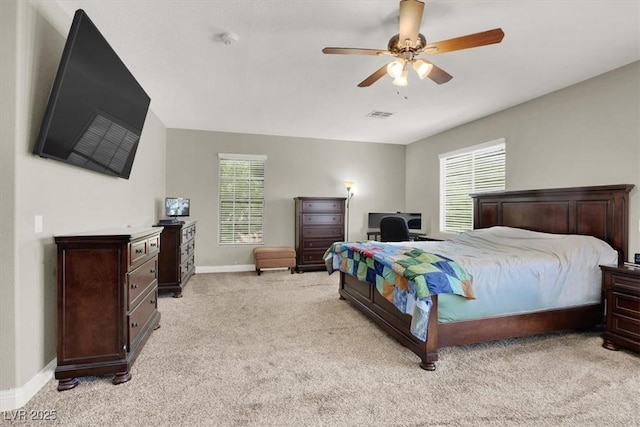 7310 Heggie Ave, Las Vegas, NV 89131 - bedroom featuring multiple windows, light carpet, and baseboards