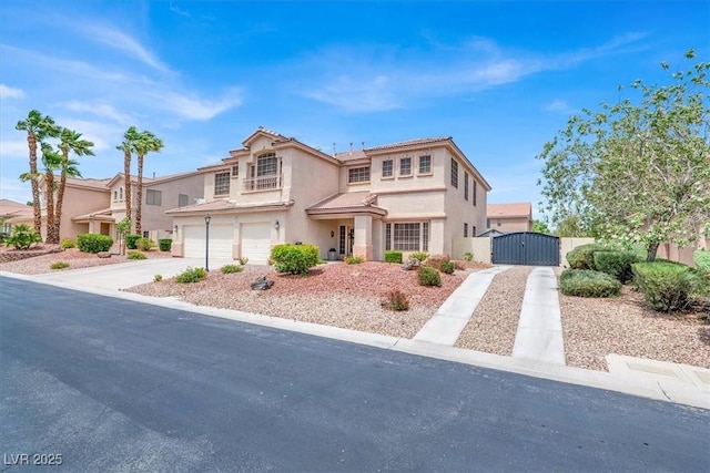 7310 Heggie Ave, Las Vegas, NV 89131 - view of front of home featuring a gate, concrete driveway, a garage, and stucco siding