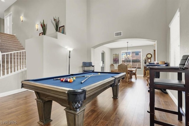 7310 Heggie Ave, Las Vegas, NV 89131 - recreation room with a towering ceiling, arched walkways, hardwood / wood-style flooring, baseboards, and billiards