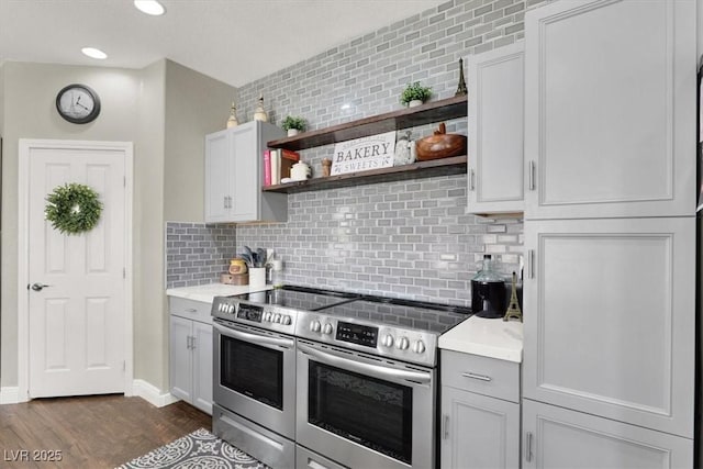 7310 Heggie Ave, Las Vegas, NV 89131 - kitchen featuring stainless steel range with electric cooktop, tasteful backsplash, open shelves, and light countertops