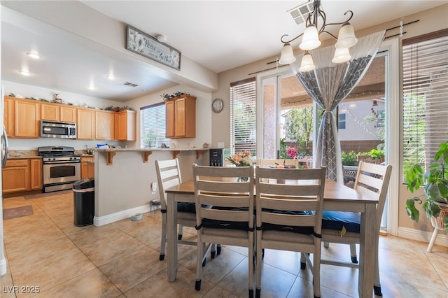 9513 Perennial View Ave, Las Vegas, NV 89148 - dining area featuring a chandelier, baseboards, and light tile patterned floors