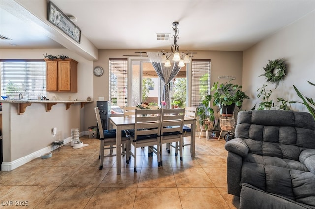 9513 Perennial View Ave, Las Vegas, NV 89148 - dining space featuring light tile patterned floors, a chandelier, and baseboards