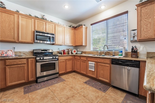 9513 Perennial View Ave, Las Vegas, NV 89148 - kitchen featuring stainless steel appliances, a sink, light tile patterned floors, recessed lighting, and light stone countertops