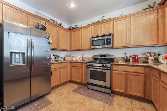 9513 Perennial View Ave, Las Vegas, NV 89148 - kitchen featuring appliances with stainless steel finishes, light tile patterned floors, light stone counters, and recessed lighting
