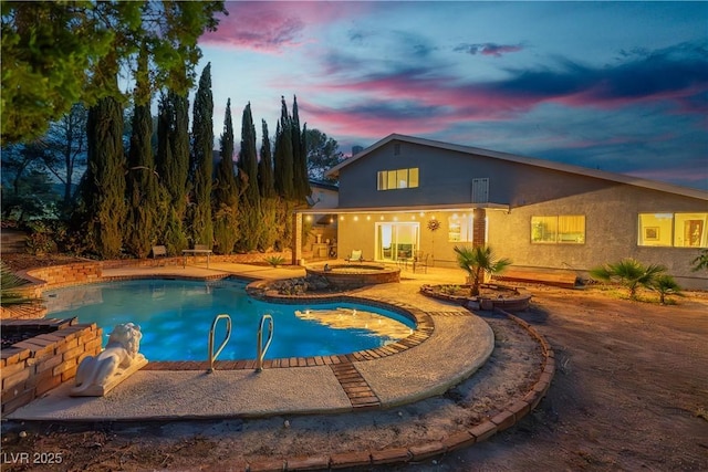 1808 Piccolo Way, Las Vegas, NV 89146 - pool at dusk with an in-ground hot tub, a patio area, and an outdoor pool