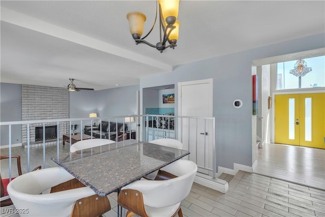 1808 Piccolo Way, Las Vegas, NV 89146 - dining space featuring a chandelier, a ceiling fan, a fireplace, and baseboards