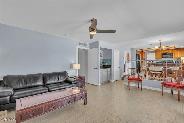 1808 Piccolo Way, Las Vegas, NV 89146 - living area featuring a ceiling fan, a chandelier, and light wood-style floors