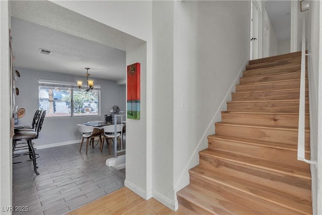 1808 Piccolo Way, Las Vegas, NV 89146 - stairway with a chandelier, baseboards, and wood finished floors