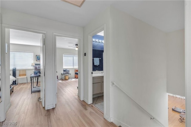 1808 Piccolo Way, Las Vegas, NV 89146 - hallway with healthy amount of natural light, light wood-style floors, an upstairs landing, and baseboards