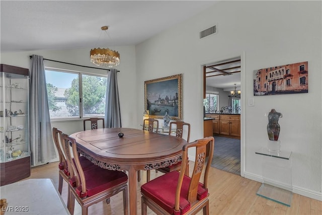 1808 Piccolo Way, Las Vegas, NV 89146 - dining space with a chandelier, lofted ceiling, light wood-style flooring, and baseboards