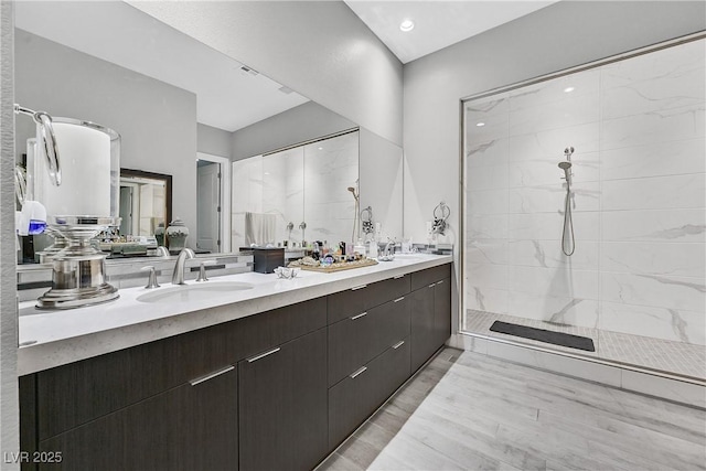 6184 Willow Rock St, Las Vegas, NV 89135 - full bathroom featuring a tile shower, double vanity, recessed lighting, and wood finished floors