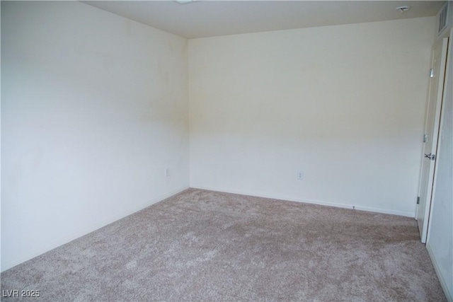 empty room with carpet flooring and baseboards