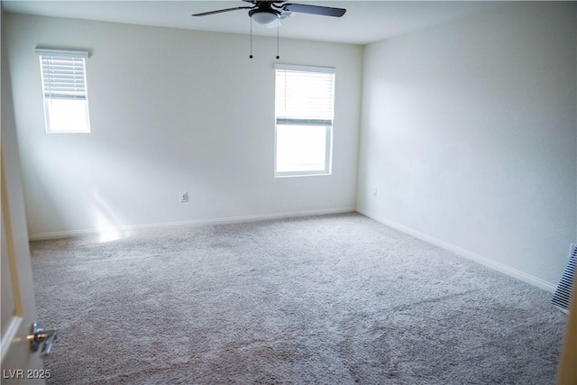 unfurnished room featuring a ceiling fan, carpet, and baseboards