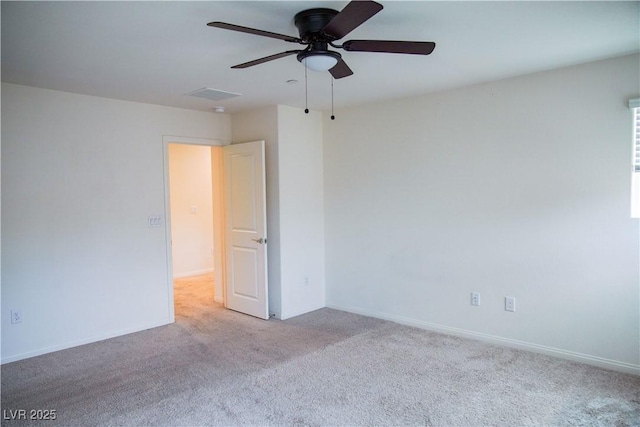unfurnished room with a ceiling fan, carpet flooring, and baseboards