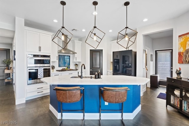 10954 Free Flow Pl, Las Vegas, NV 89138 - kitchen with a sink, stainless steel appliances, an island with sink, white cabinetry, and decorative light fixtures