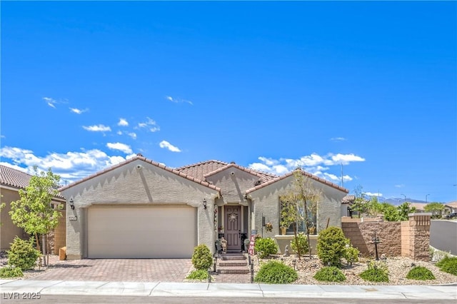 8269 Skye Peak St, Las Vegas, NV 89166 - view of front of property featuring an attached garage, decorative driveway, stucco siding, and a tile roof