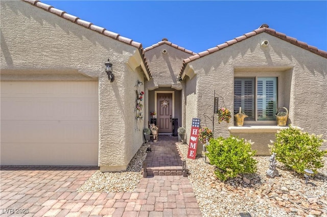 8269 Skye Peak St, Las Vegas, NV 89166 - property entrance with a garage, stucco siding, and a tiled roof