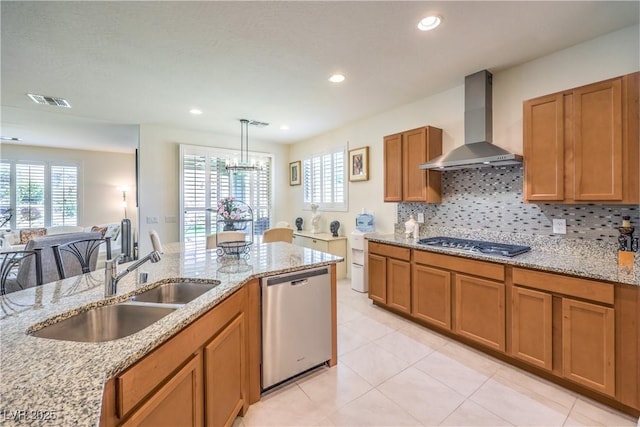 8269 Skye Peak St, Las Vegas, NV 89166 - kitchen with appliances with stainless steel finishes, wall chimney exhaust hood, brown cabinets, a sink, and plenty of natural light