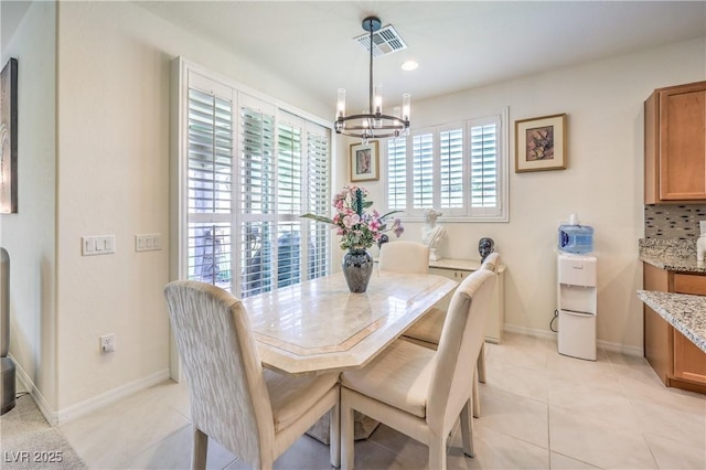 8269 Skye Peak St, Las Vegas, NV 89166 - dining room with a chandelier, light tile patterned floors, and baseboards