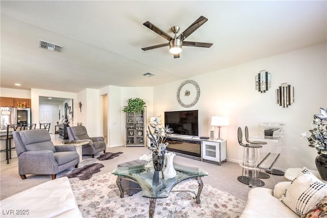 8269 Skye Peak St, Las Vegas, NV 89166 - living room featuring light carpet, a ceiling fan, and baseboards
