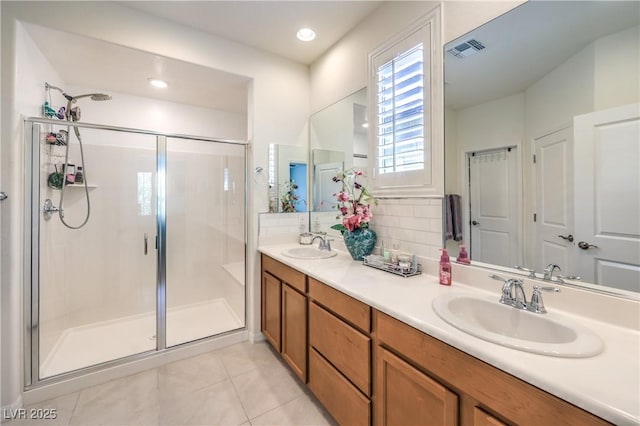 8269 Skye Peak St, Las Vegas, NV 89166 - bathroom featuring a shower stall, tile patterned floors, and double vanity