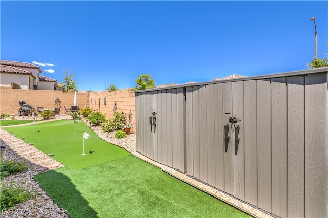 8269 Skye Peak St, Las Vegas, NV 89166 - fenced backyard with an area to practice putting