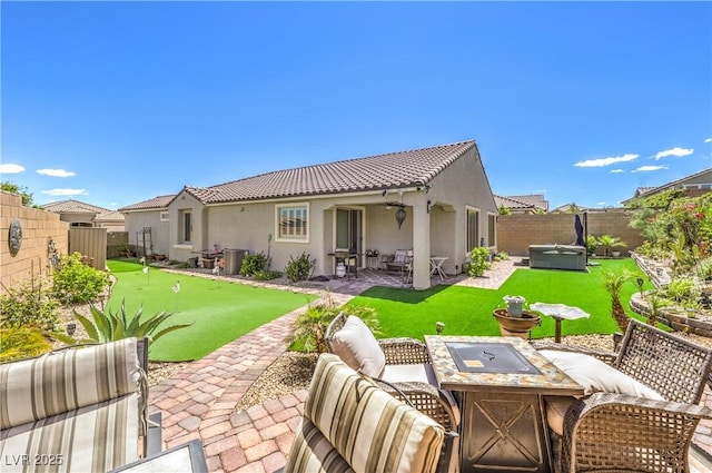 8269 Skye Peak St, Las Vegas, NV 89166 - rear view of property with an area to practice putting, a patio, stucco siding, a fenced backyard, and an outdoor living space with a fire pit
