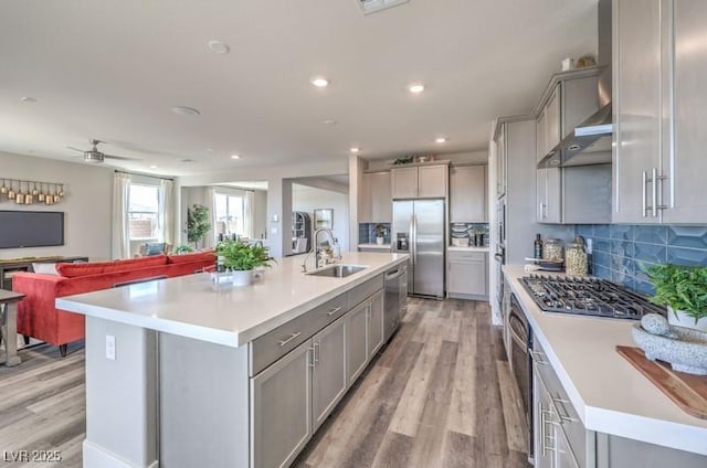 1220 Eva Creek Dr Unit 35, North Las Vegas, NV 89084 - kitchen featuring gray cabinetry, appliances with stainless steel finishes, a sink, light wood-type flooring, and open floor plan