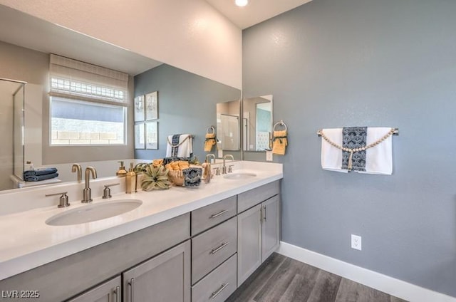 1220 Eva Creek Dr Unit 35, North Las Vegas, NV 89084 - full bath featuring wood finished floors, baseboards, an enclosed shower, and double vanity