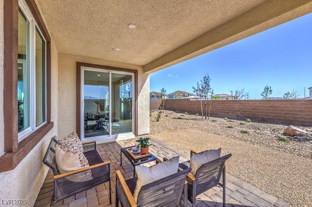 1220 Eva Creek Dr Unit 35, North Las Vegas, NV 89084 - view of patio / terrace with an outdoor living space and a fenced backyard