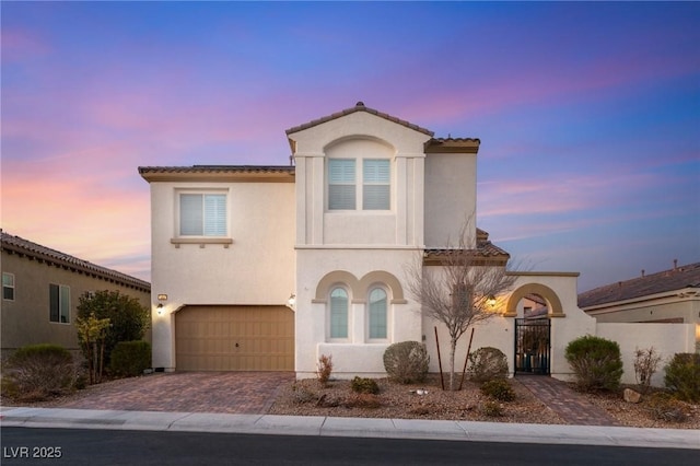 352 Dandelion Brook Ct, Las Vegas, NV 89148 - mediterranean / spanish home featuring a garage, decorative driveway, stucco siding, and a tiled roof