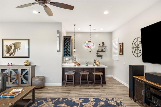 352 Dandelion Brook Ct, Las Vegas, NV 89148 - indoor wet bar featuring wood finished floors, ceiling fan, baseboards, recessed lighting, and decorative light fixtures