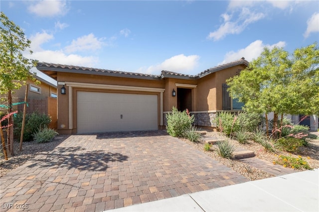 485 Pebble Run Ave, Henderson, NV 89011 - view of front of house featuring an attached garage, decorative driveway, stucco siding, and a tiled roof