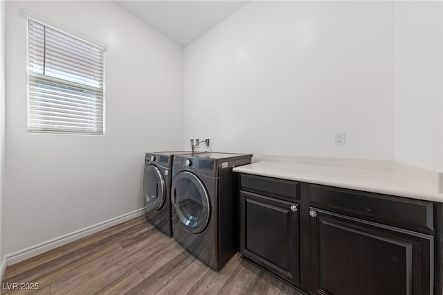 485 Pebble Run Ave, Henderson, NV 89011 - laundry room featuring washing machine and dryer, light wood-style floors, cabinet space, and baseboards